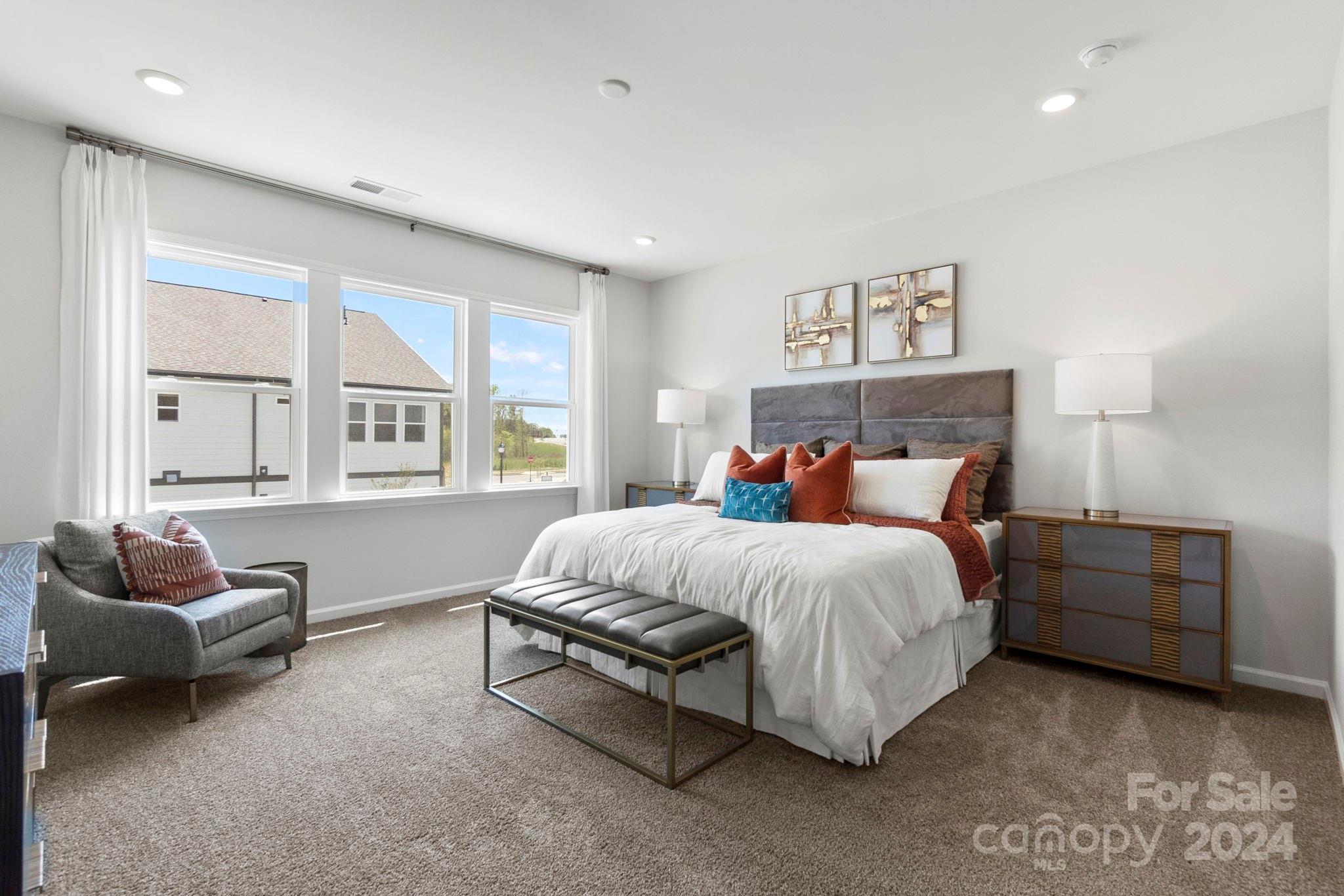 1133 Lost Cv Road Indian Land, SC 29707 - Photo 21 of 42 a spacious bedroom with a bed and a couch