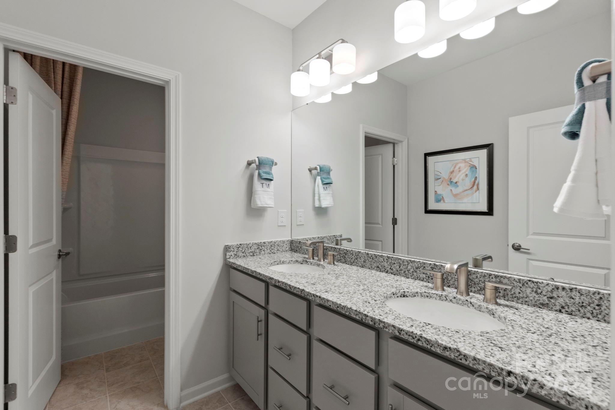 1133 Lost Cv Road Indian Land, SC 29707 - Photo 28 of 42 a bathroom with a granite countertop sink and a mirror