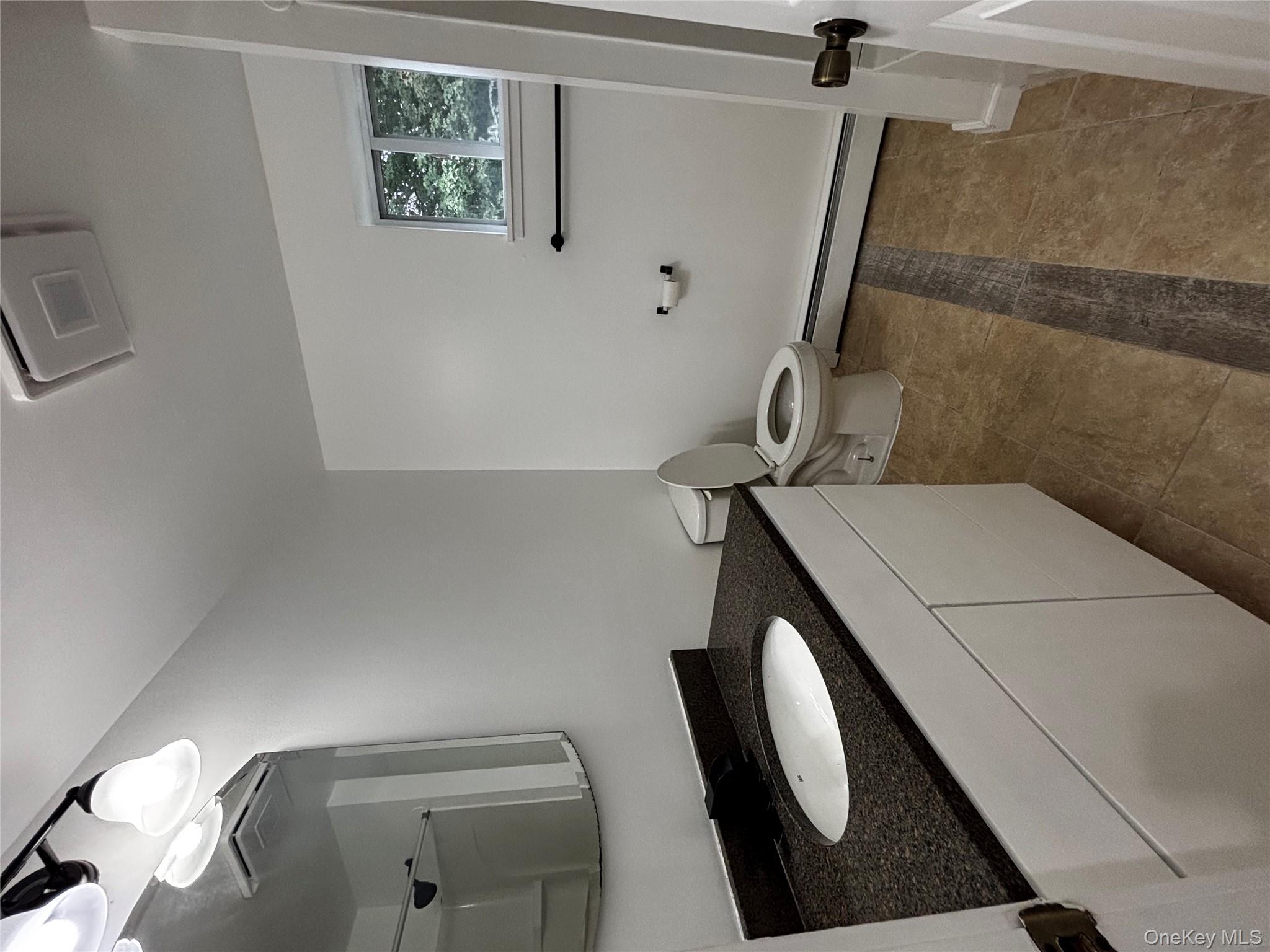 333 Bingham Road Marlboro, NY 12542 - Photo 22 of 27 a bathroom with a granite countertop sink and a mirror