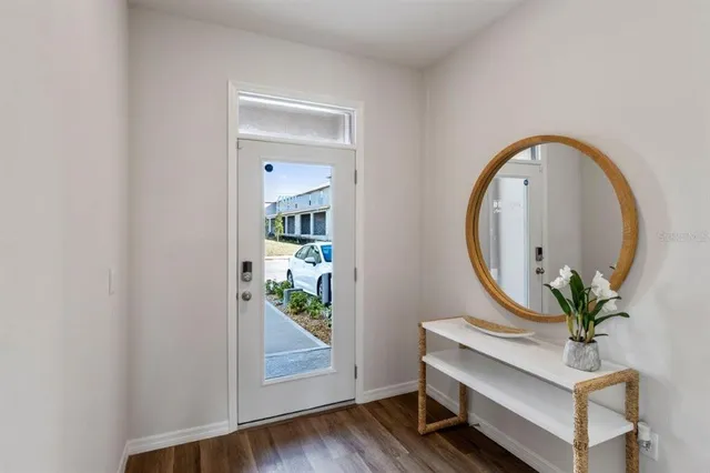 a room with painting on the wall and a potted plant