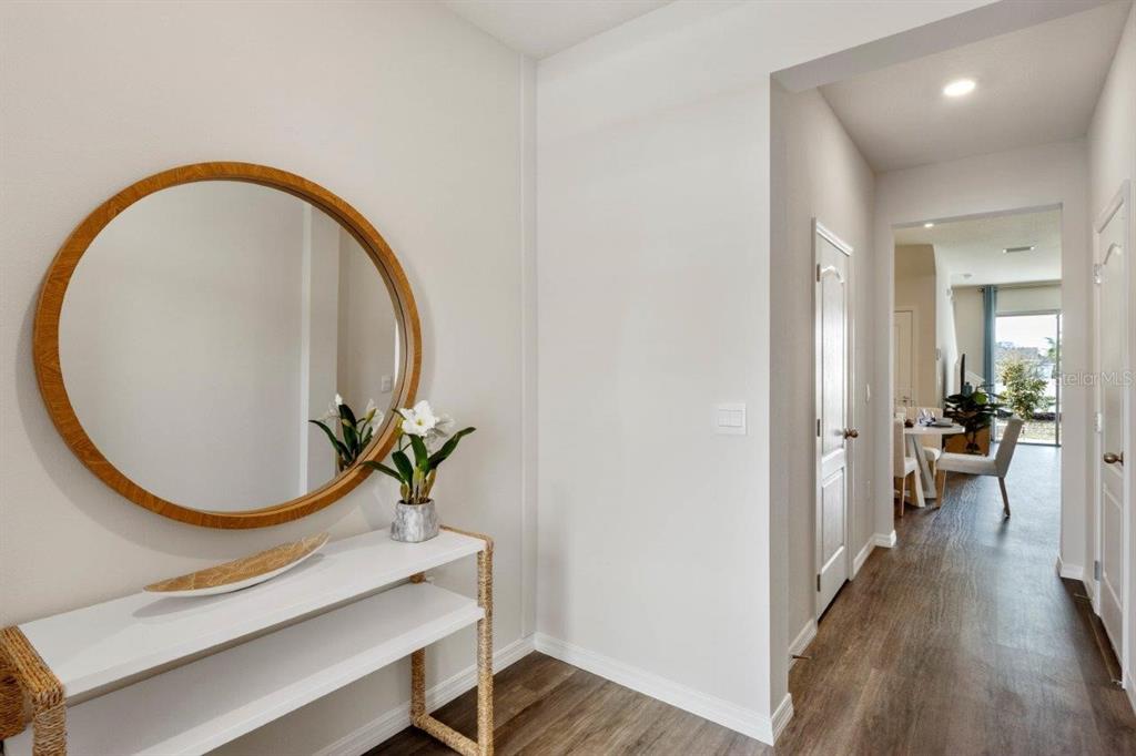 2717 Gladiola Road Kissimmee, FL 34759 - Photo 3 of 25 wooden floor with a potted plant and a mirror view