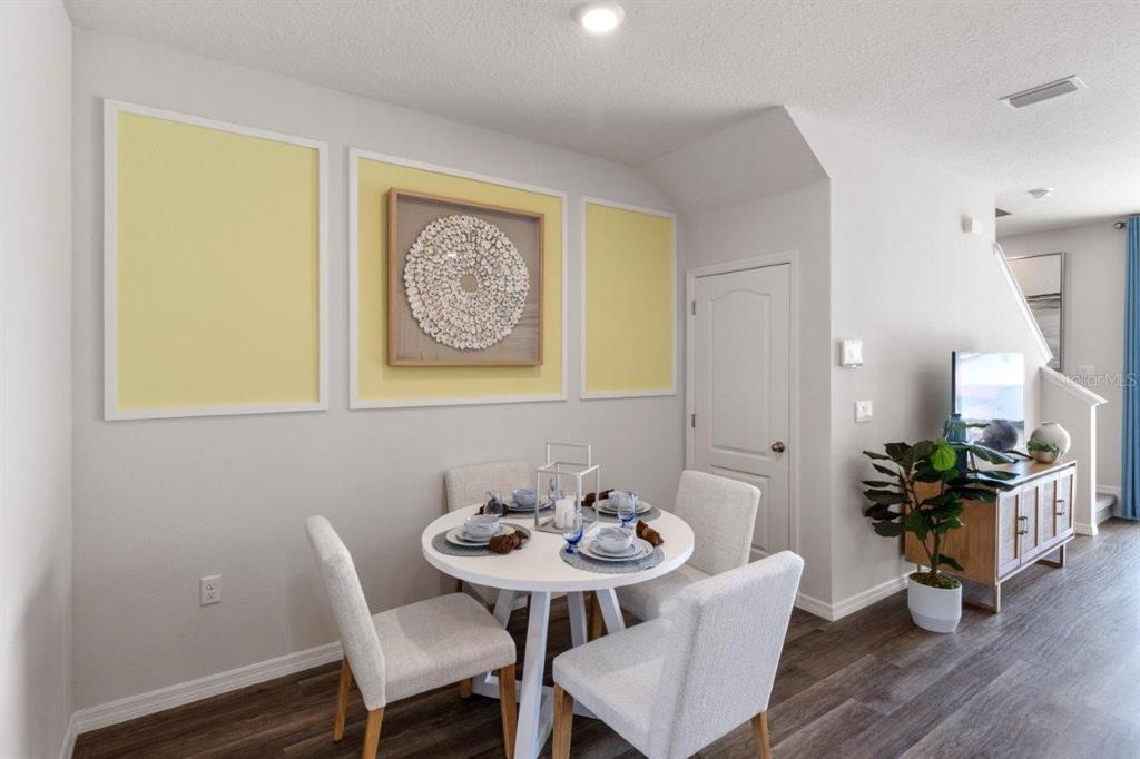 2717 Gladiola Road Kissimmee, FL 34759 - Photo 4 of 25 a view of a dining room with furniture and wooden floor