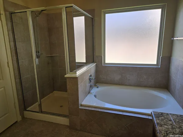 a bathroom with a bathtub and a shower