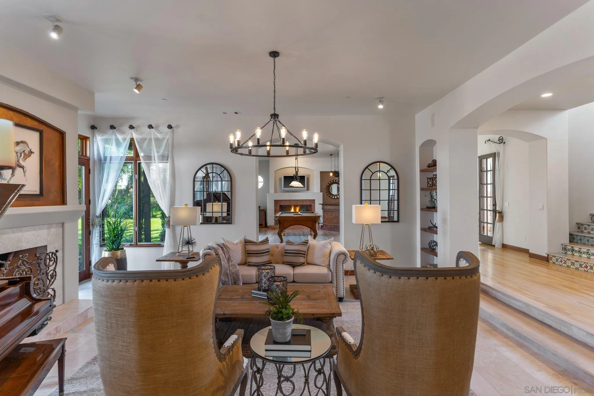 3381 Calle Margarita Encinitas, CA 92024 - Photo 13 of 47 a living room with fireplace furniture and a chandelier