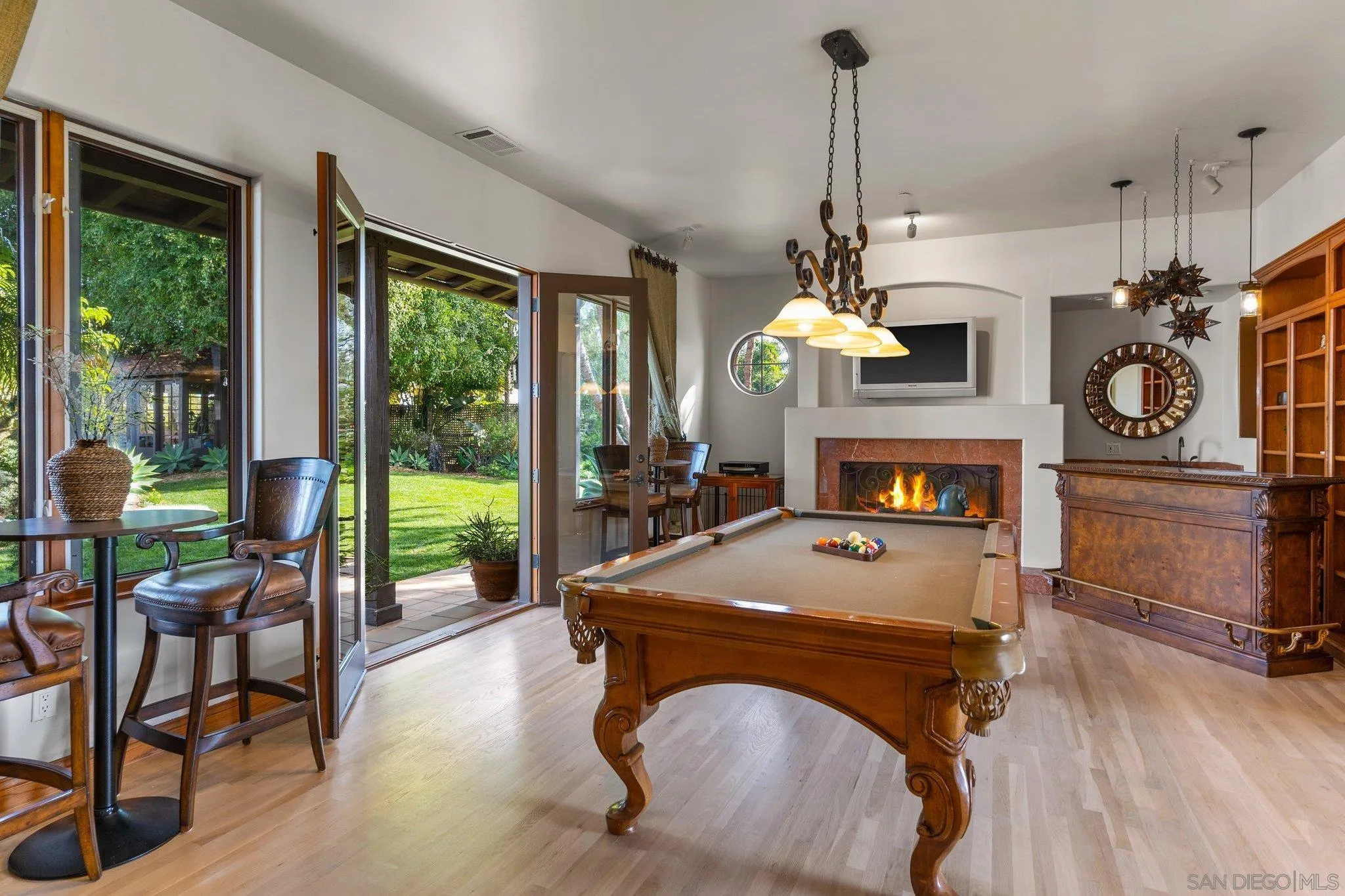3381 Calle Margarita Encinitas, CA 92024 - Photo 14 of 47 a living room with furniture a fireplace and a floor to ceiling window