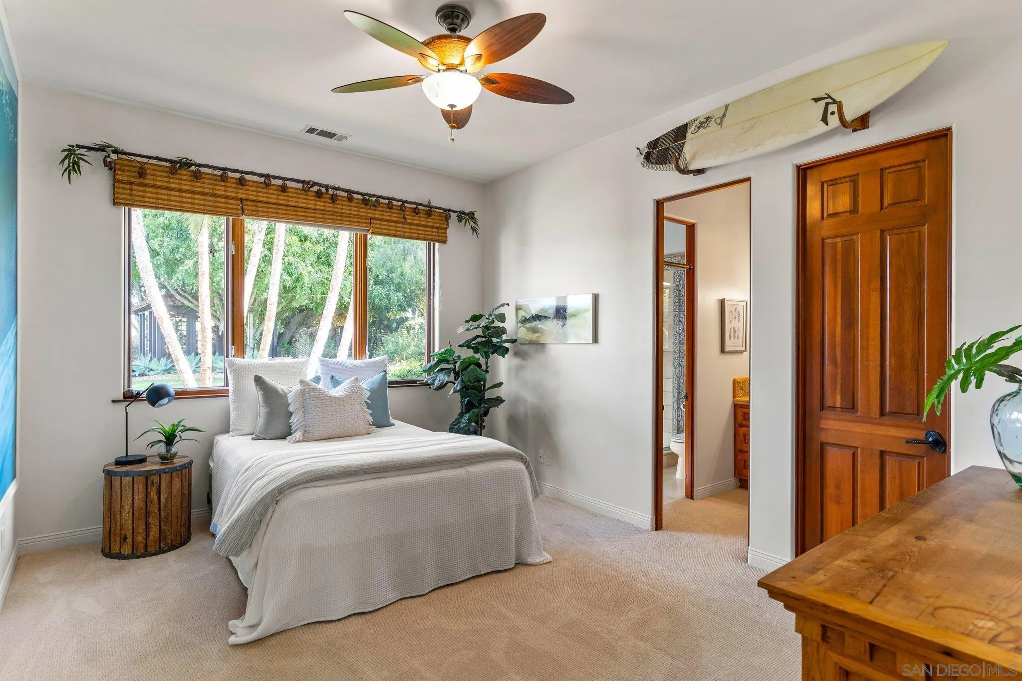 3381 Calle Margarita Encinitas, CA 92024 - Photo 26 of 47 a bedroom with a bed and a chandelier