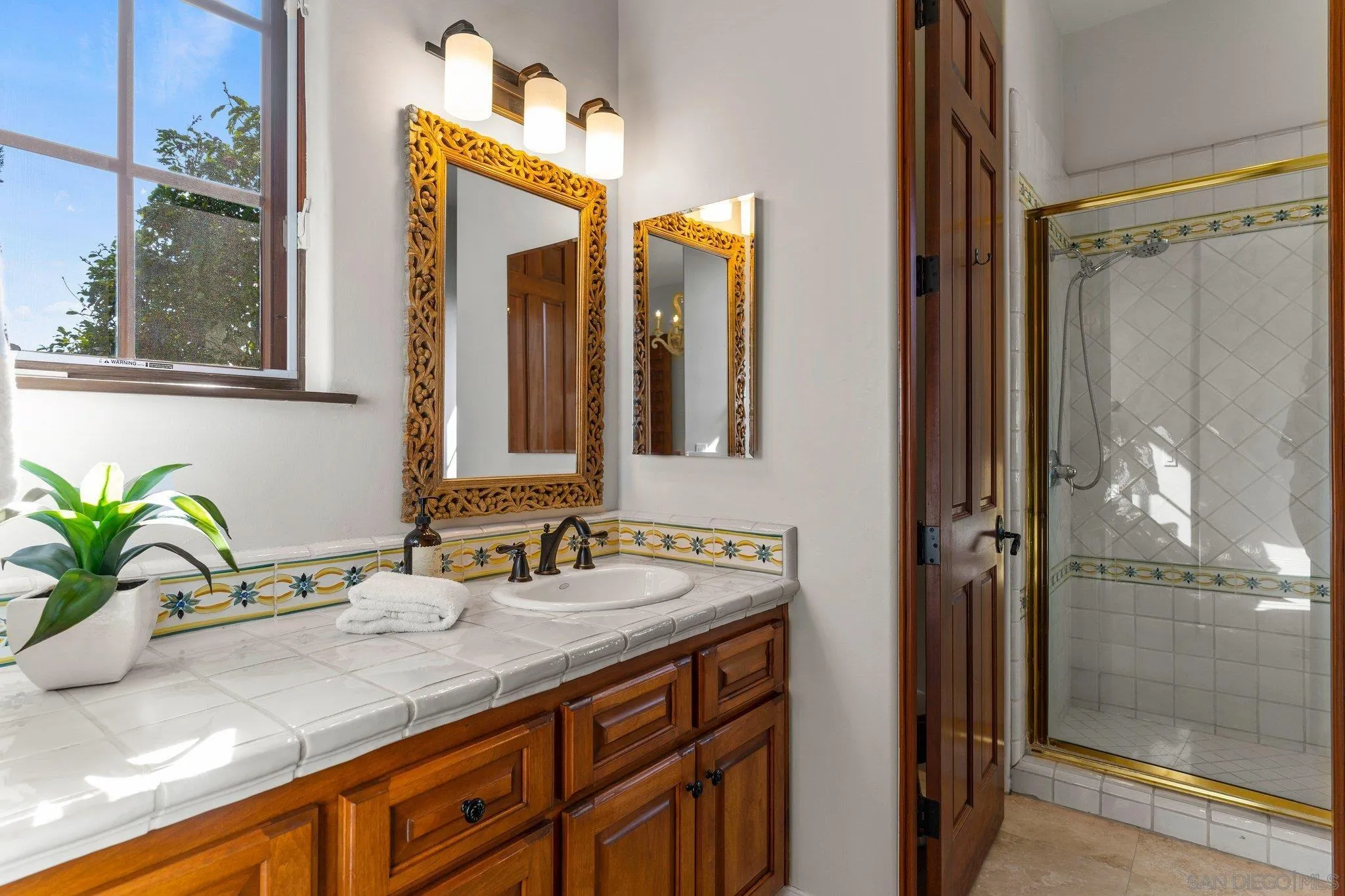 3381 Calle Margarita Encinitas, CA 92024 - Photo 30 of 47 a bathroom with a granite countertop sink and a mirror