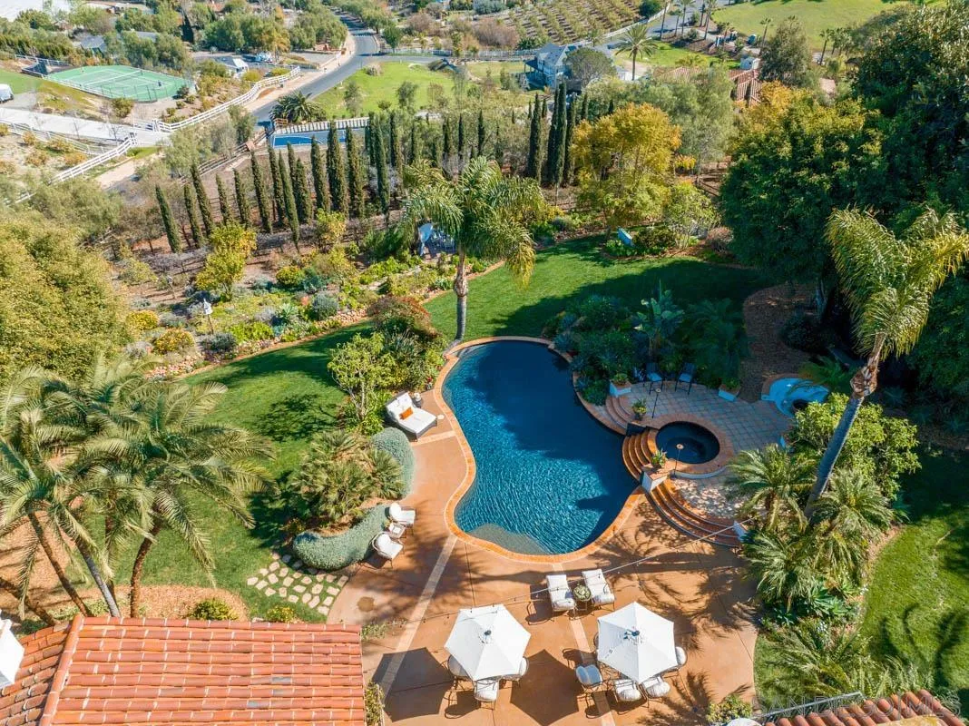 3381 Calle Margarita Encinitas, CA 92024 - Photo 33 of 47 a view of a swimming pool with some plants and flowers