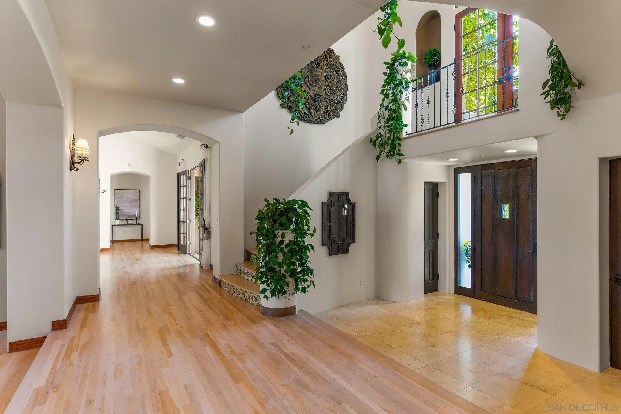 3381 Calle Margarita Encinitas, CA 92024 - Photo 4 of 47 a view of an entryway with wooden floor and a chandelier