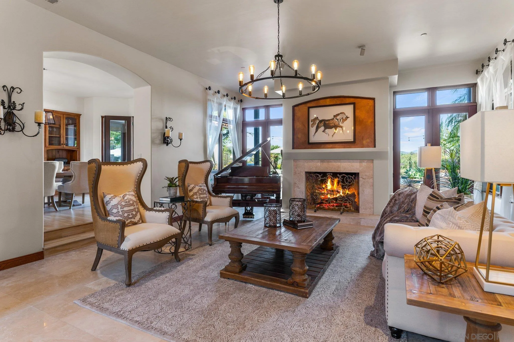 3381 Calle Margarita Encinitas, CA 92024 - Photo 5 of 47 a living room with furniture a chandelier and a fireplace
