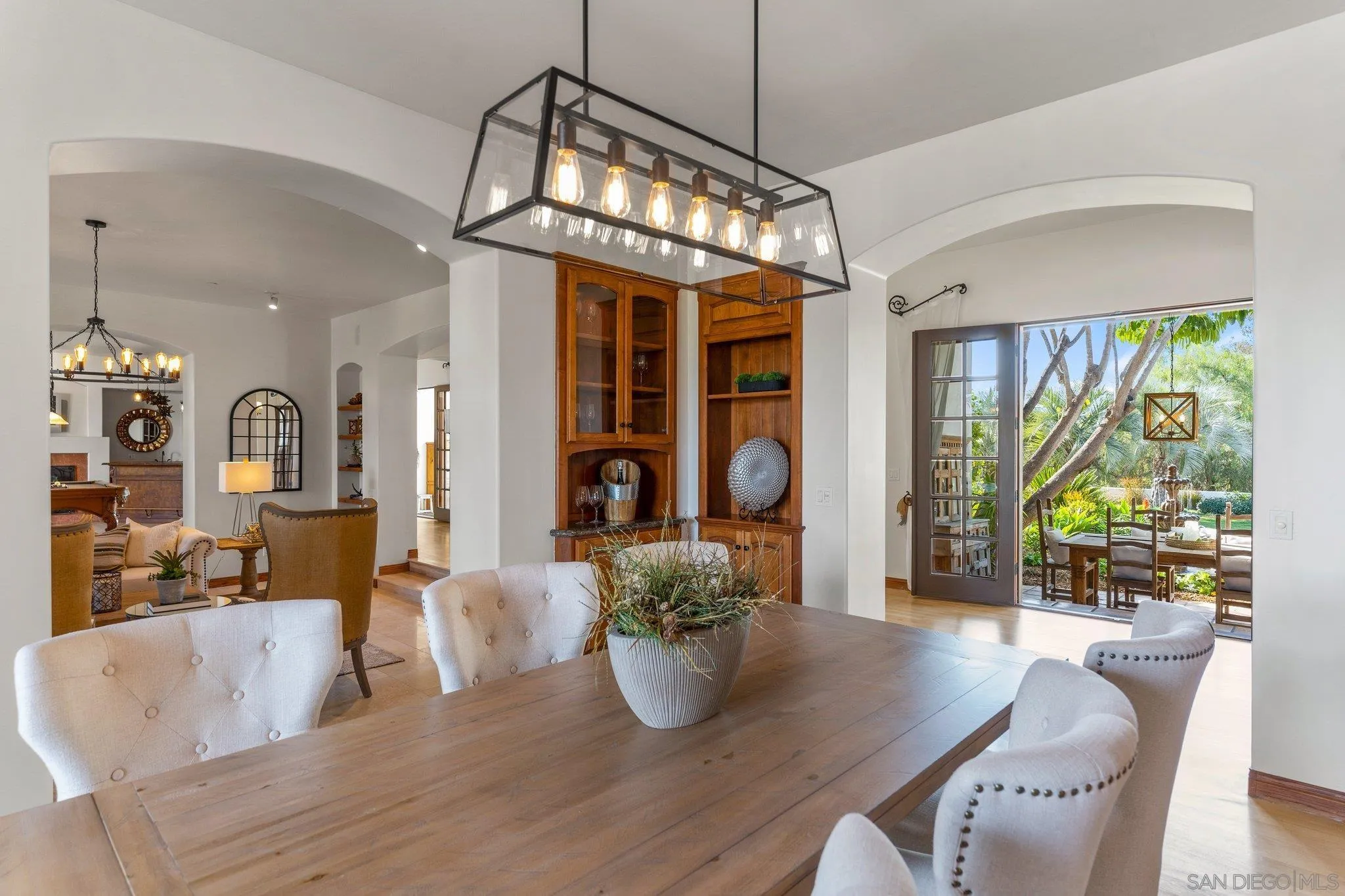3381 Calle Margarita Encinitas, CA 92024 - Photo 7 of 47 a dining room with furniture a chandelier and wooden floor