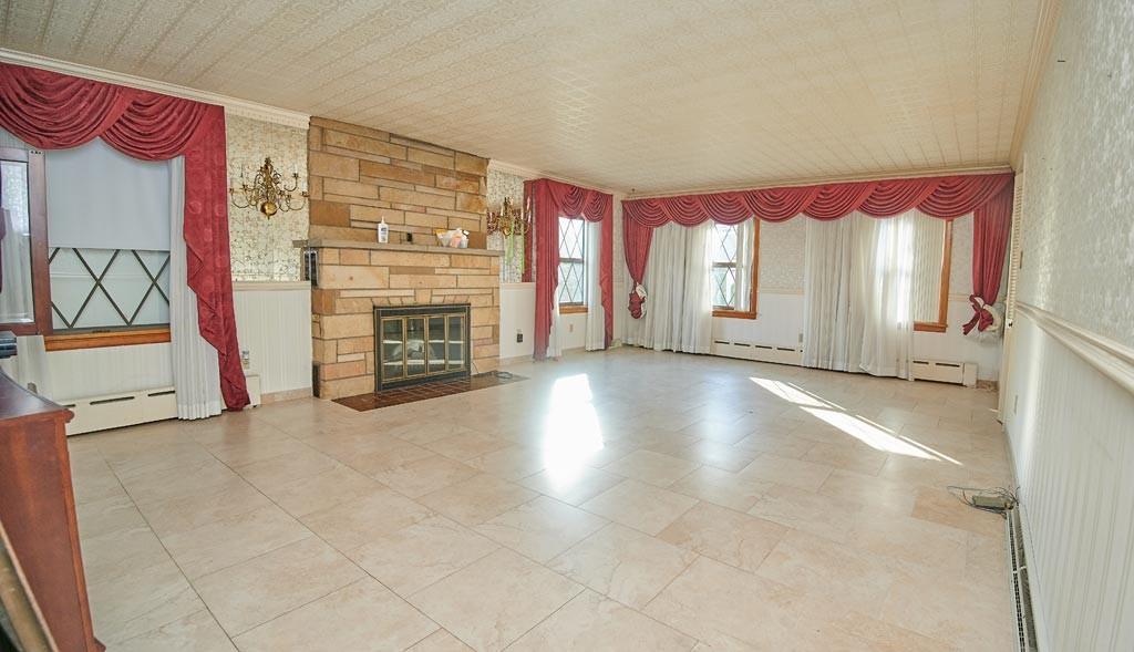 100 Herring Road Uniontown, PA 15401 - Photo 6 of 25 a view of a livingroom with wooden floor and a fireplace