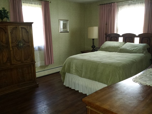 400 Walnut Plain Road Rochester, MA 02770 - Photo 11 of 24 a bedroom with a bed and wooden floor