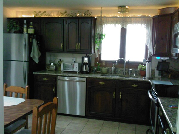 400 Walnut Plain Road Rochester, MA 02770 - Photo 6 of 24 a kitchen with a sink refrigerator and microwave