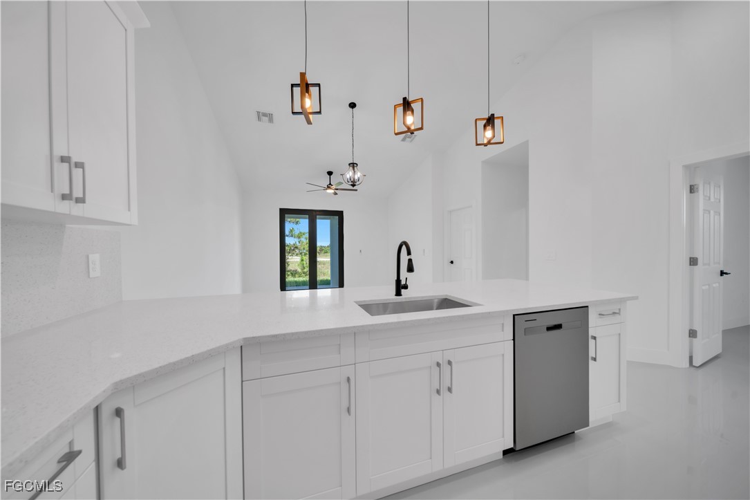 1110 Eisenhower Boulevard Lehigh Acres, FL 33974 - Photo 15 of 35 a utility room with cabinets