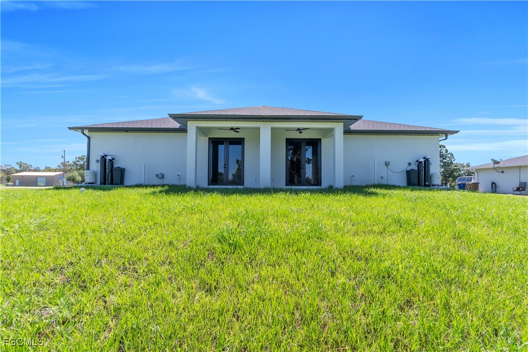 1110 Eisenhower Boulevard Lehigh Acres, FL 33974 - Photo 29 of 35 a view of a house with a yard