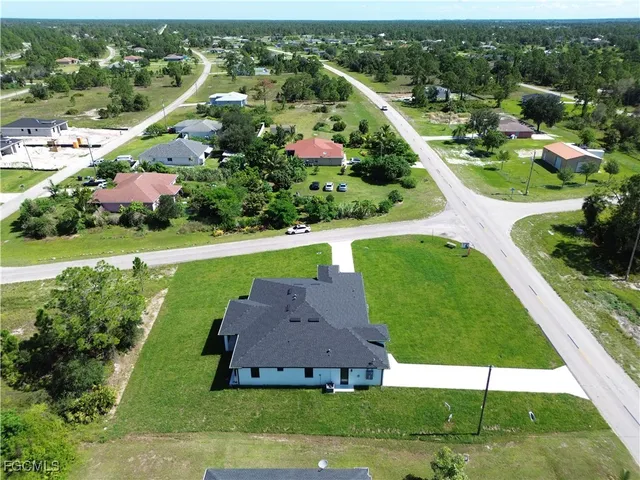 an aerial view of residential houses with outdoor space and lake view