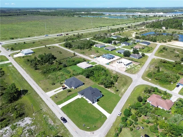 an aerial view of a residential house with a yard