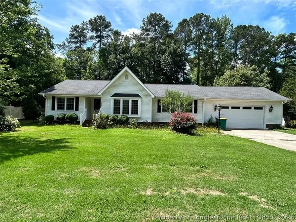 a front view of a house with a yard porch and furniture