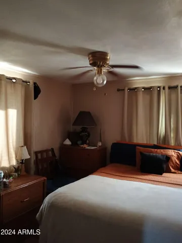 a bedroom with a bed and a chandelier