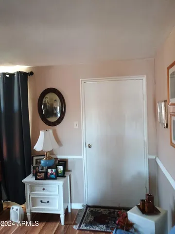 a room with a wooden floor and a mirror