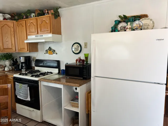 a kitchen with stainless steel appliances a stove a refrigerator and a refrigerator