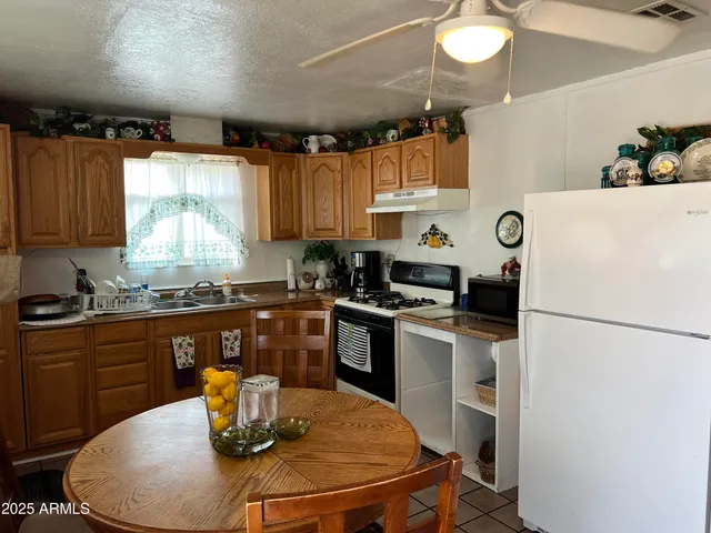 a kitchen with a sink appliances and cabinets