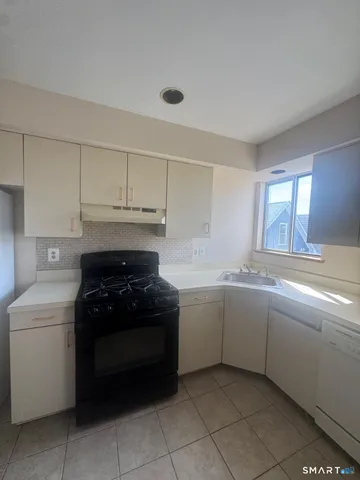 a kitchen with a cabinets and white stove