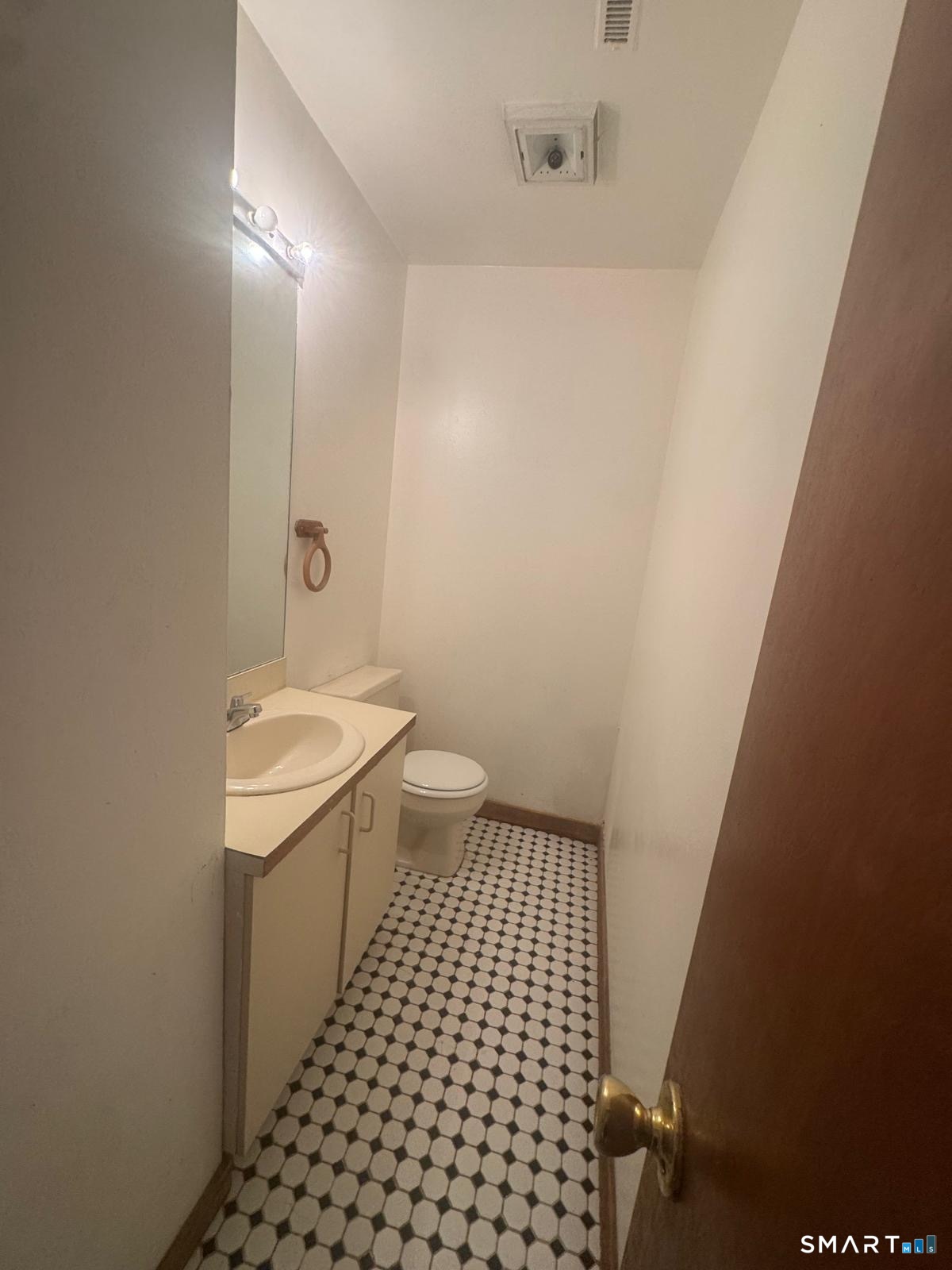 204 Wheeler Avenue, Unit 9 Bridgeport, CT 06606 - Photo 8 of 11 a bathroom with a sink a toilet and shower