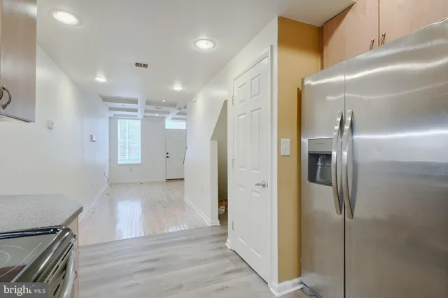 a view of a hallway with wooden floor