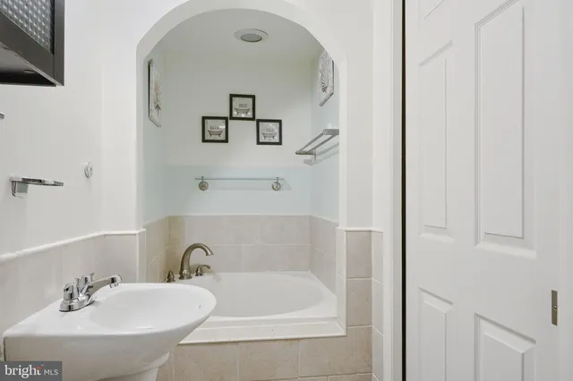 a white bath tub sitting next to a white sink