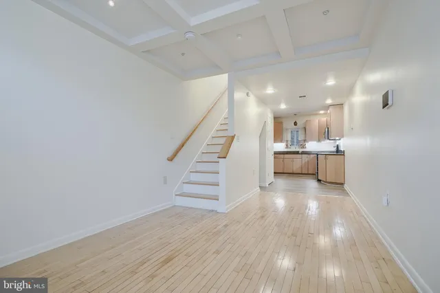 a view of a kitchen with wooden floor and stairs