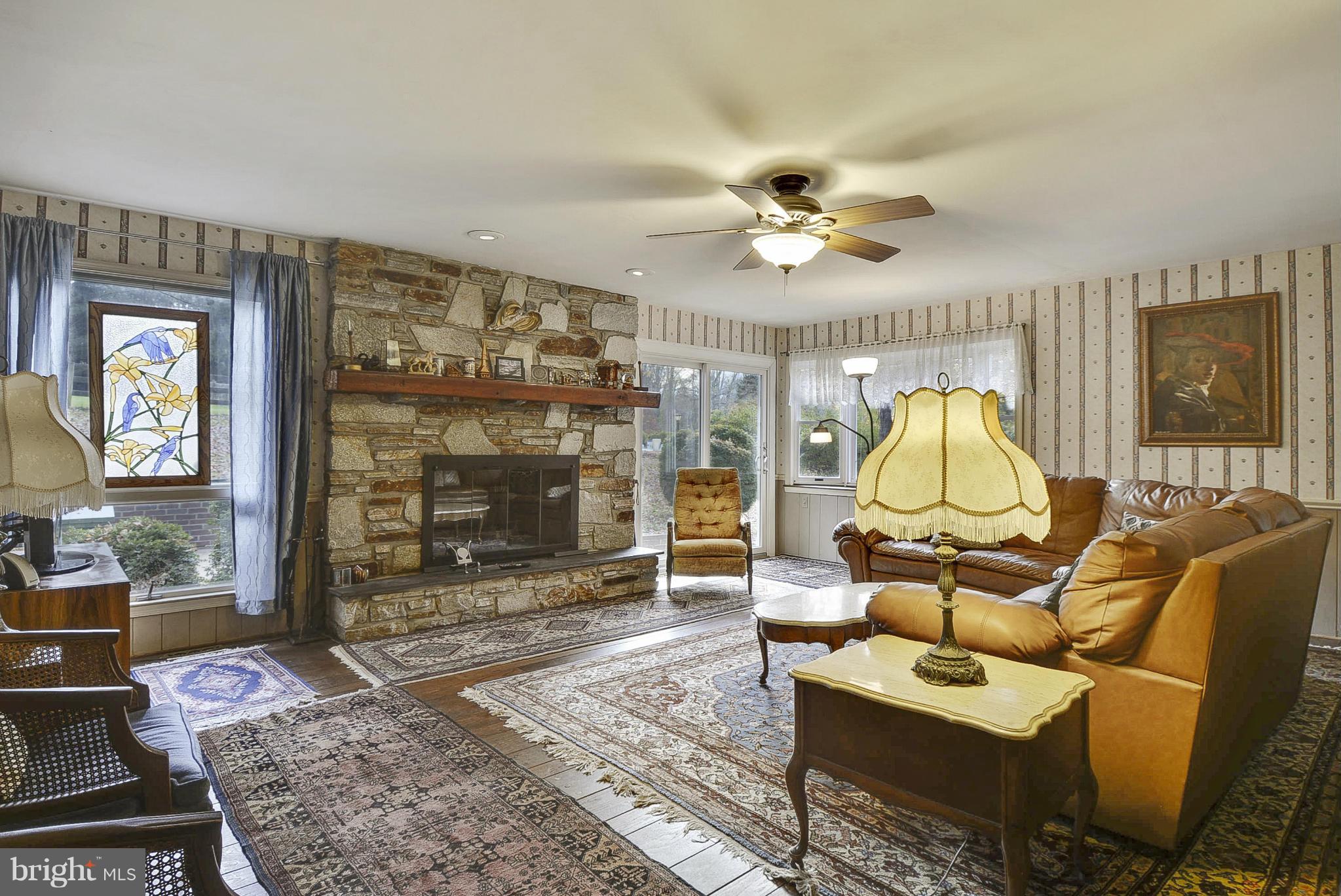 2227 Carroll Mill Road Phoenix, MD 21131 - Photo 23 of 30 a living room with furniture a flat screen tv and a fireplace