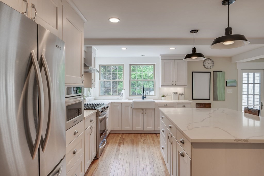 290 Concord Road Bedford, MA 01730 - Photo 3 of 41 a kitchen with stainless steel appliances granite countertop a refrigerator a sink dishwasher a oven with white cabinets and wooden floor
