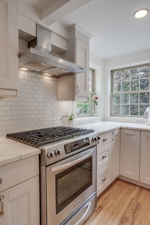 290 Concord Road Bedford, MA 01730 - Photo 5 of 41 a stove top oven sitting inside of a kitchen