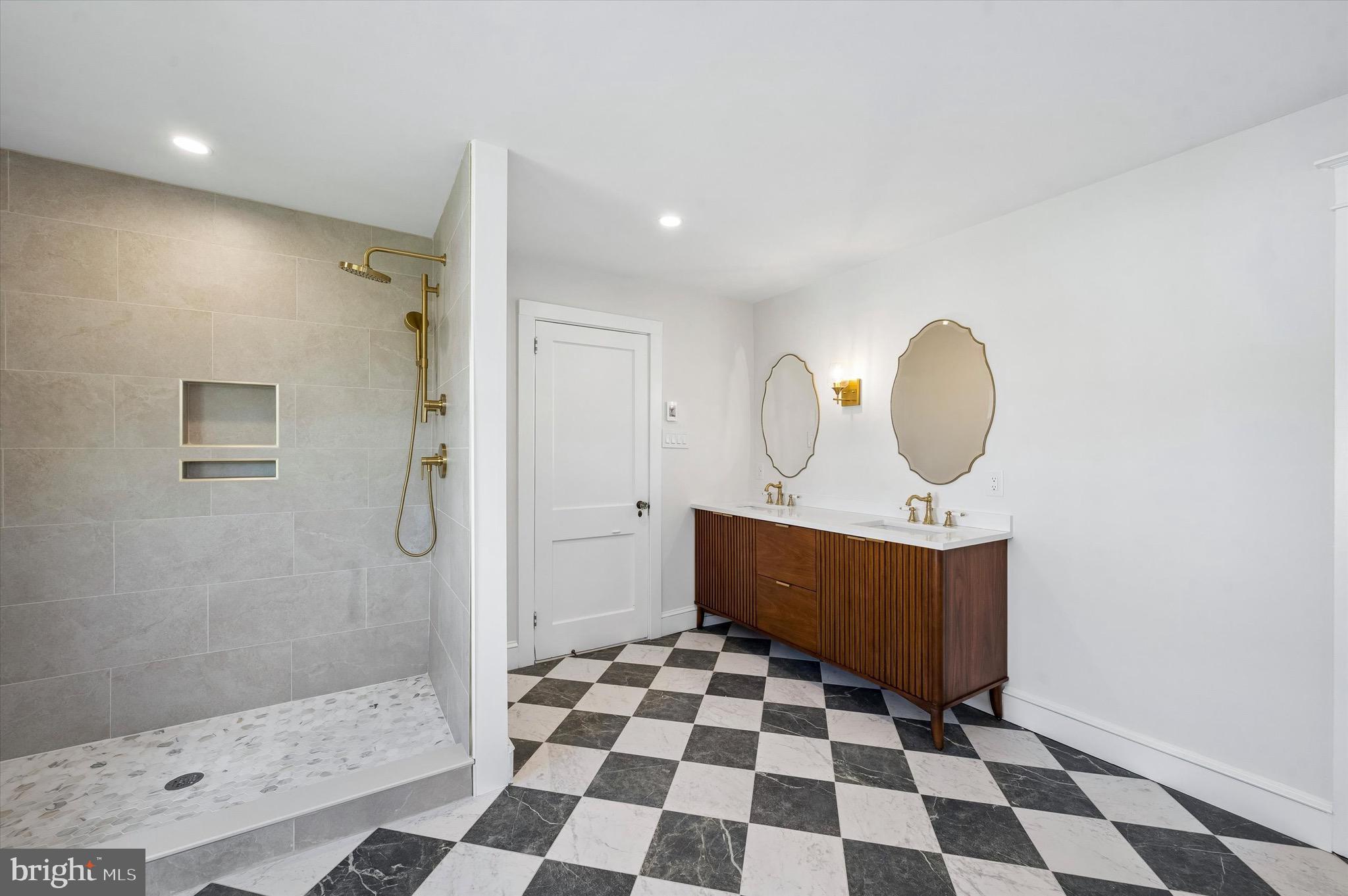 100 Yale Road Havertown, PA 19083 - Photo 23 of 35 a view of a bathroom with a sink a mirror and shower