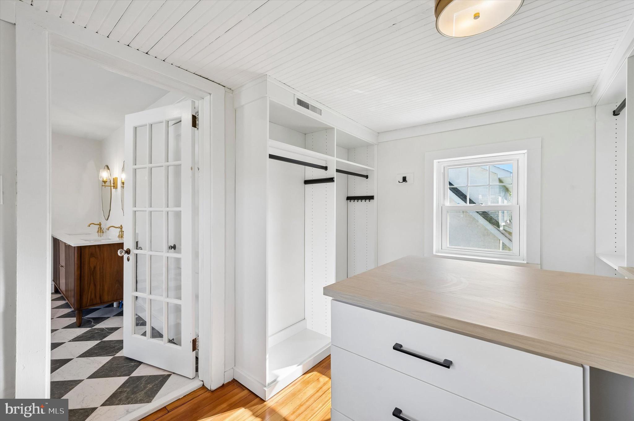 100 Yale Road Havertown, PA 19083 - Photo 25 of 35 a view of a hallway with wooden floor and cabinet with windows