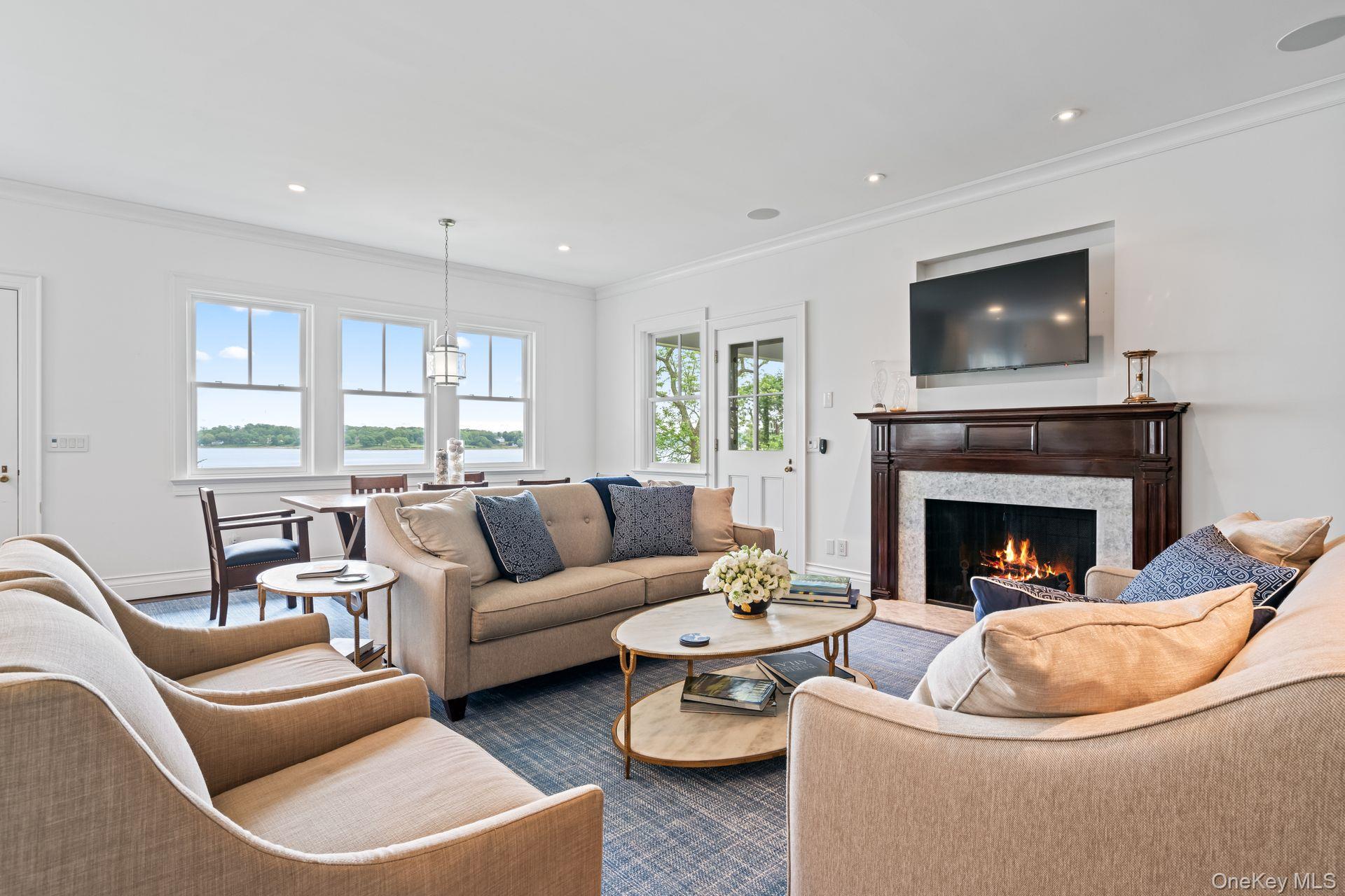 998 West Shore Road Mill Neck, NY 11765 - Photo 12 of 36 a living room with furniture a window and a fireplace
