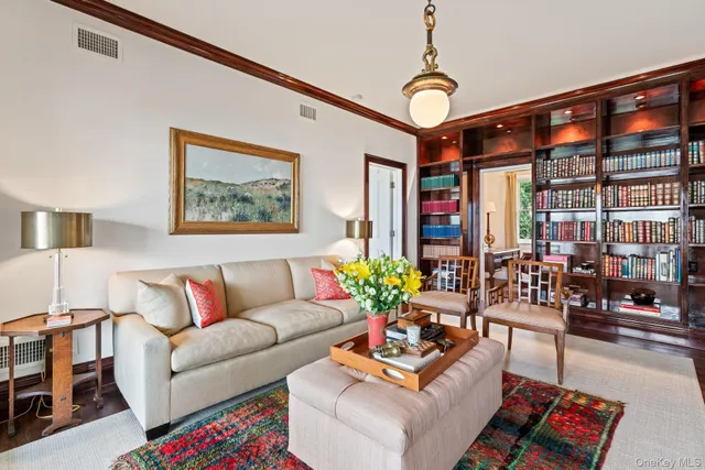a living room with furniture and flowers
