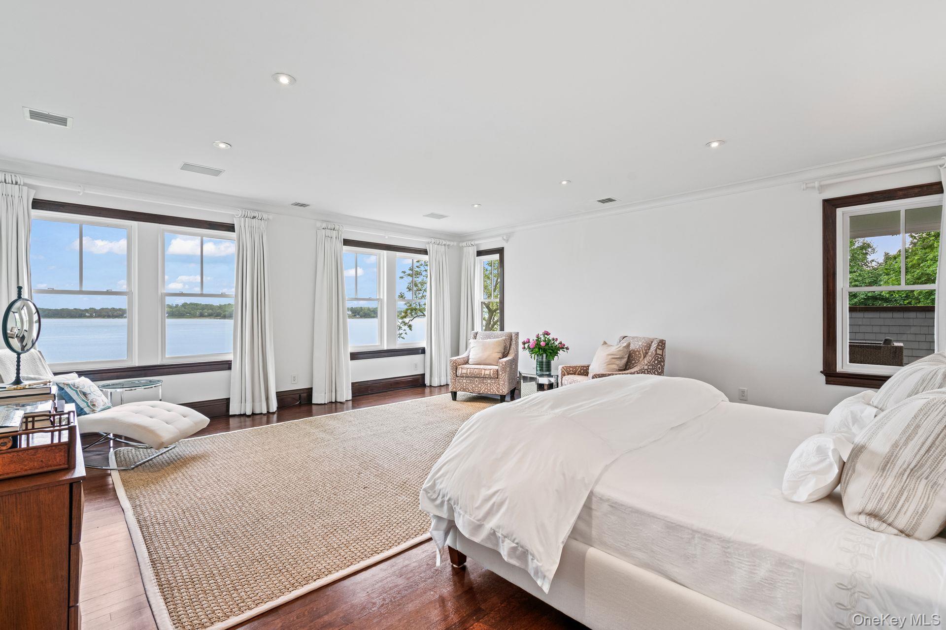 998 West Shore Road Mill Neck, NY 11765 - Photo 17 of 36 a bedroom with a bed and glass windows
