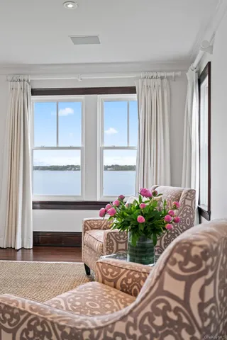 a living room with a bed and a window