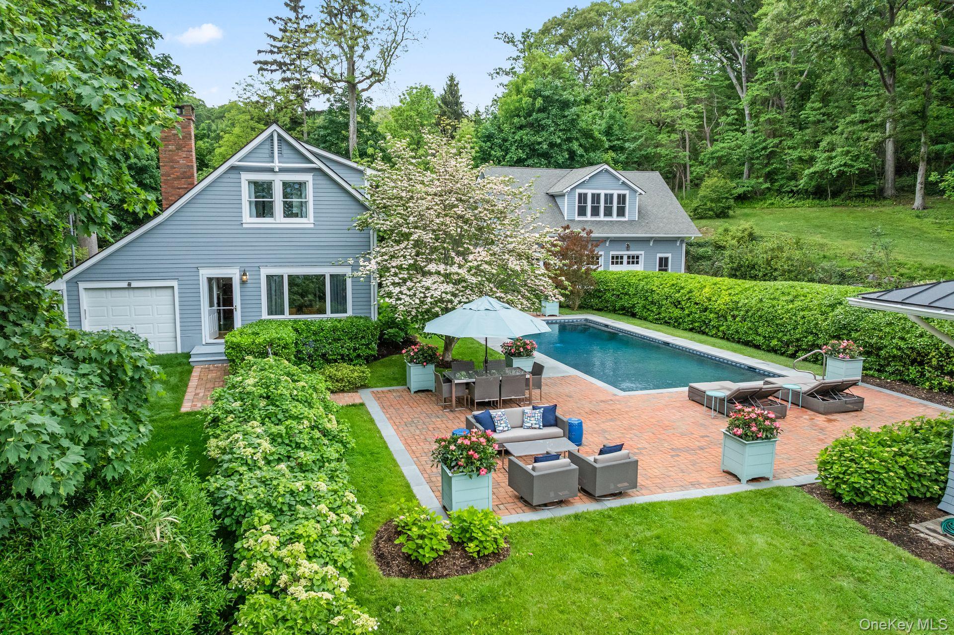 998 West Shore Road Mill Neck, NY 11765 - Photo 30 of 36 a front view of a house with garden