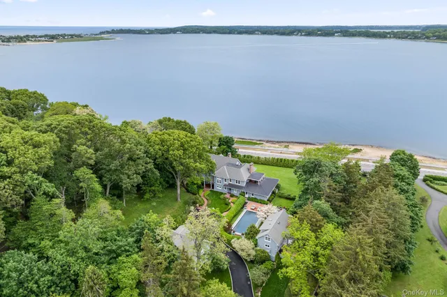 a backyard of a house with lots of green space and a lake view