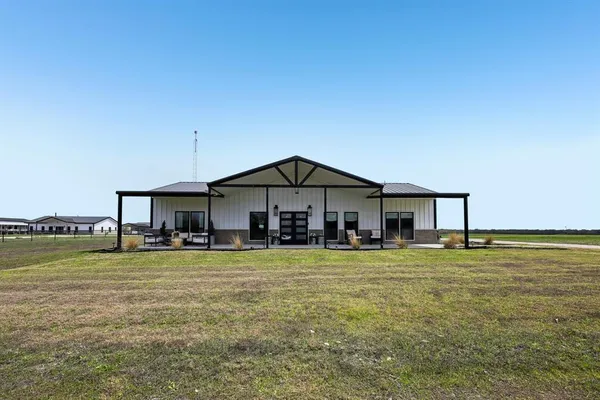 a view of a house with swimming pool and a yard