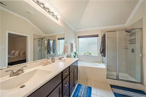 a bathroom with a double vanity sink mirror double and shower