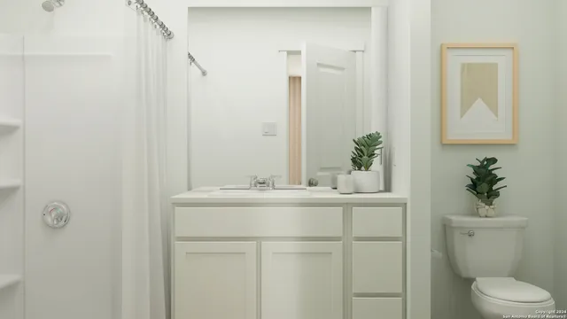 a bathroom with a sink a toilet and a mirror