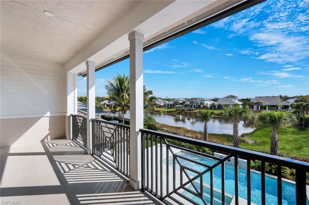 16728 Enclave Circle Naples, FL 34110 - Photo 28 of 49 Balcony with view of pool area, a residential view, and a water view