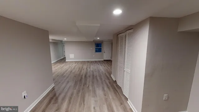 a view of hallway with wooden floor