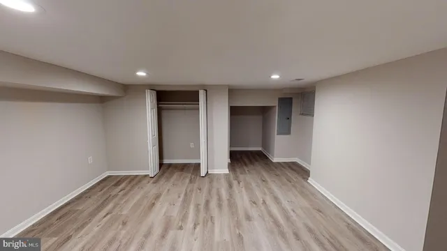 a view of an empty room with wooden floor