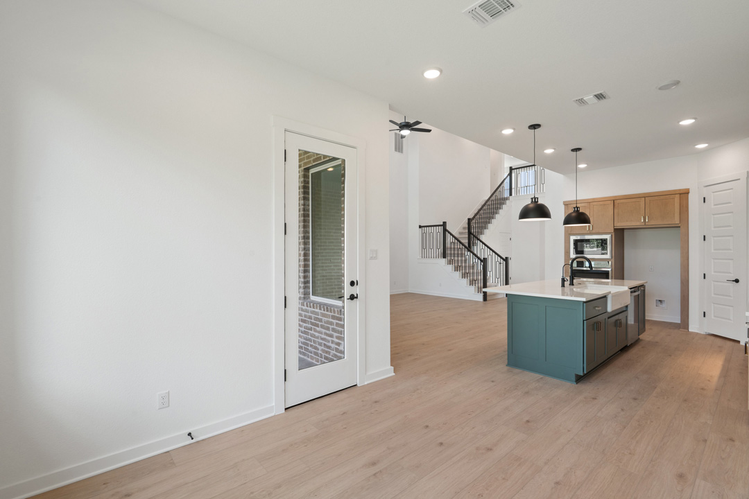 1114 Blue Moon Drive Georgetown, TX 78628 - Photo 18 of 39 an empty room with wooden floor and stairs